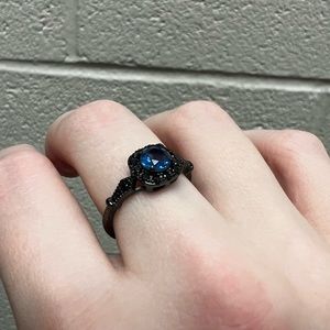 Black metal, aquamarine ring